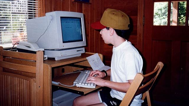 Young Wesley writing at computer